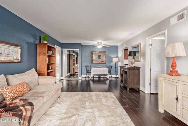 living room with dark hardwood / wood-style floors and ceiling fan