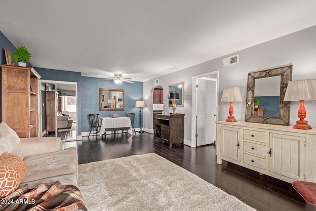 living room featuring dark hardwood / wood-style floors and ceiling fan