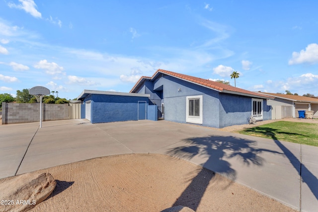 view of front of property featuring fence and stucco siding