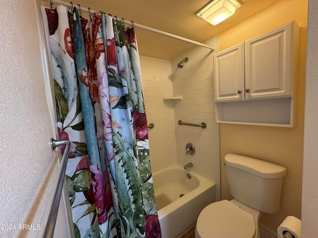 bathroom featuring a textured ceiling, shower / bath combo, and toilet