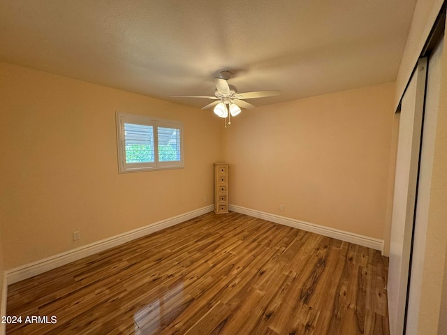 unfurnished bedroom featuring wood-type flooring and ceiling fan