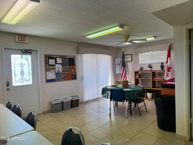 tiled dining area featuring ceiling fan