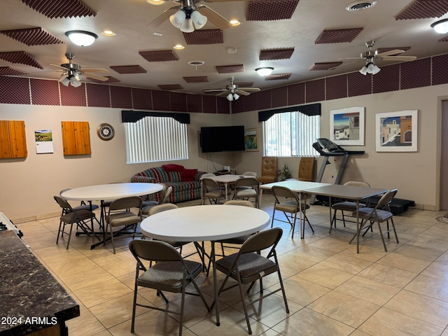 dining space with ceiling fan and light tile patterned floors