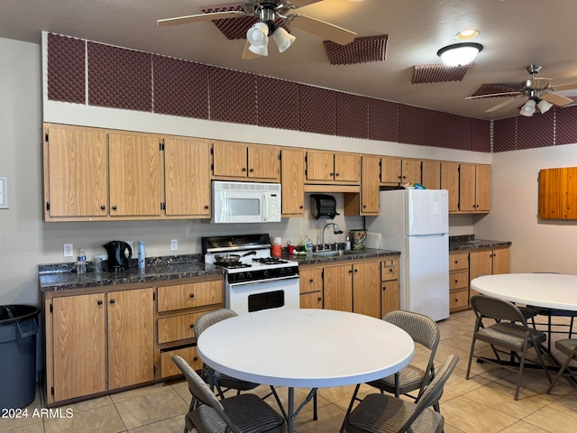 kitchen featuring white appliances, sink, light tile patterned floors, and ceiling fan