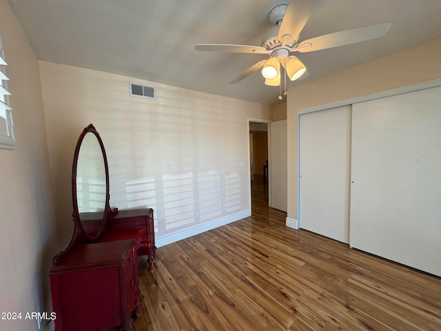 bedroom with wood-type flooring, a closet, and ceiling fan