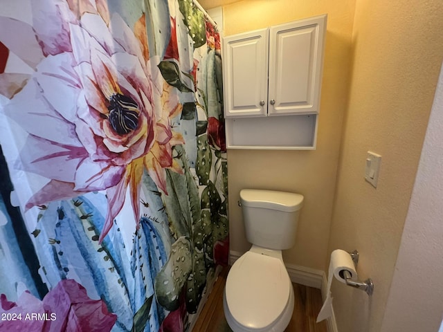 bathroom featuring hardwood / wood-style floors and toilet