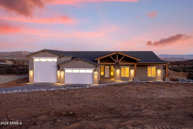 view of front of property featuring a mountain view and a garage