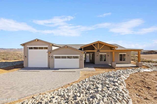 single story home with a porch and a garage