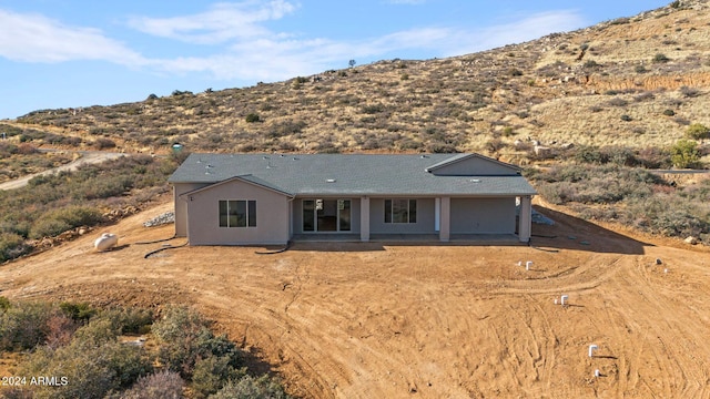 view of front facade with a mountain view and a patio