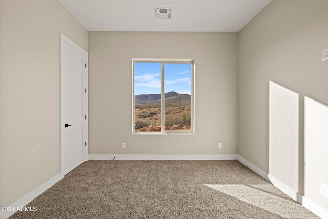 carpeted spare room with a mountain view