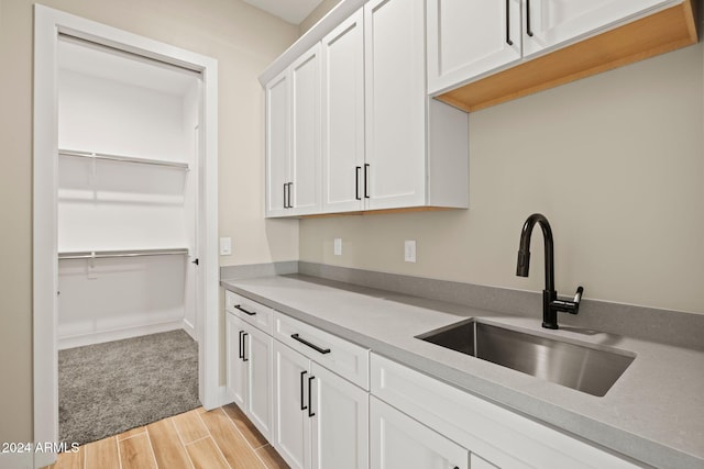 kitchen with white cabinetry and sink