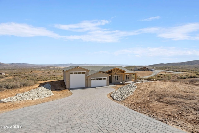 ranch-style home with a mountain view and a garage