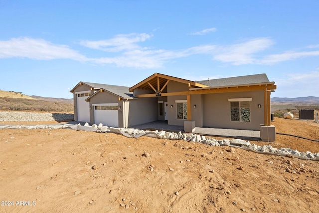 ranch-style house with a mountain view and a garage