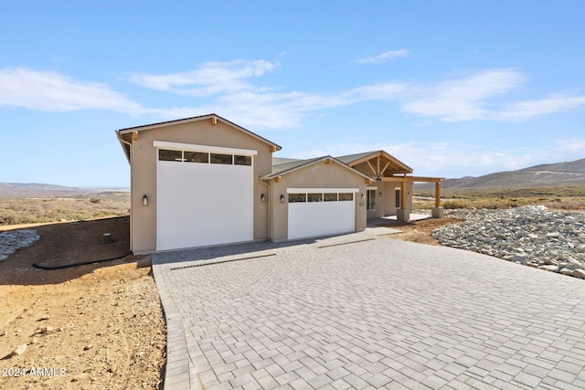 view of front facade with a mountain view and a garage