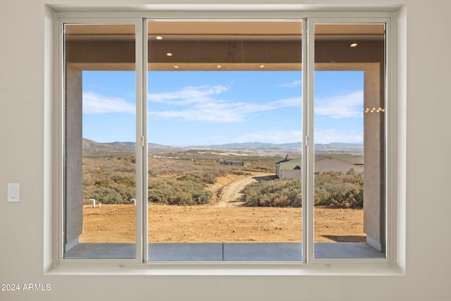 doorway to outside featuring a mountain view