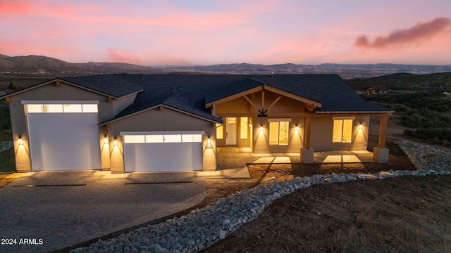 view of front of home with a mountain view and a garage