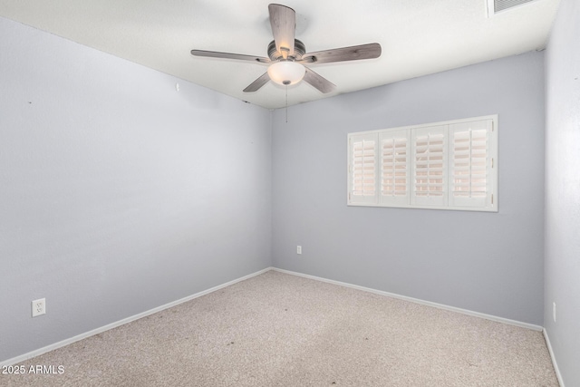 spare room featuring carpet floors, a ceiling fan, and baseboards