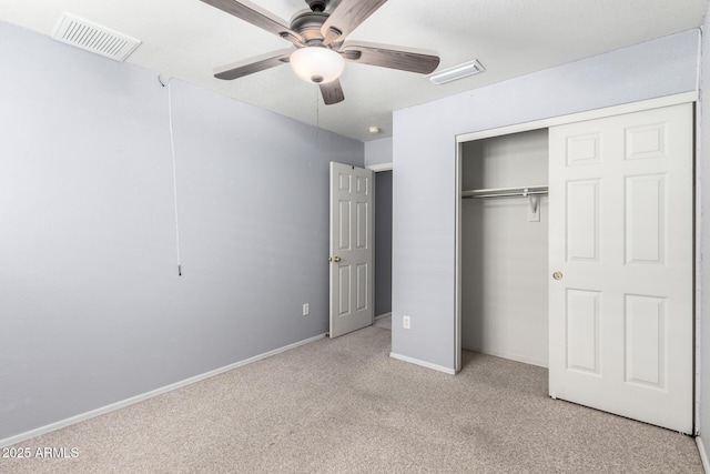 unfurnished bedroom featuring baseboards, a closet, visible vents, and carpet flooring