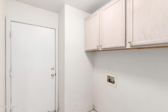 clothes washing area with cabinet space and washer hookup