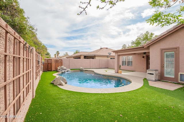 view of pool featuring a ceiling fan, a fenced backyard, a patio, and a lawn