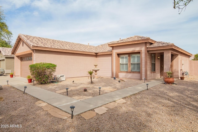 view of front facade with an attached garage and stucco siding