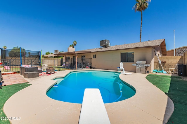 1263 W Del Rio St, Chandler, AZ 85224 - view of pool featuring a trampoline, a patio area, a diving board, a fenced backyard, and area for grilling