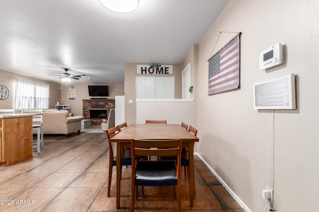 1263 W Del Rio St, Chandler, AZ 85224 - dining area with a brick fireplace, ceiling fan, and light tile patterned floors
