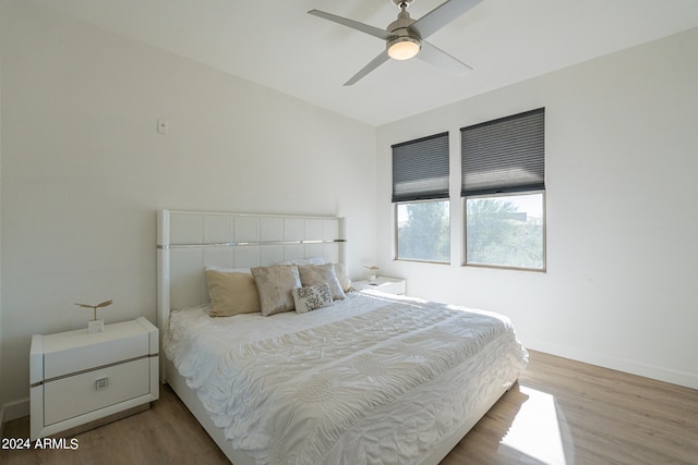 bedroom with wood-type flooring and ceiling fan