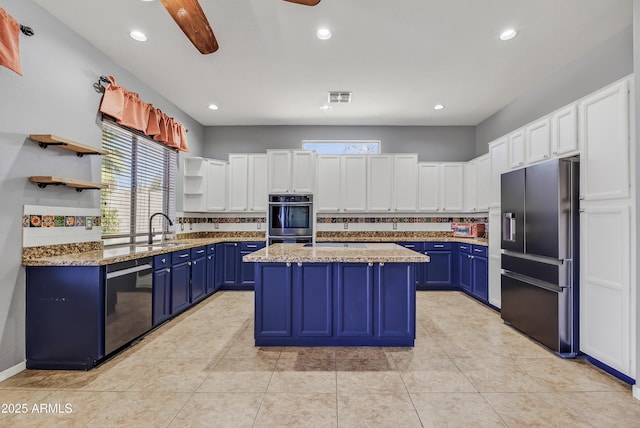 10897 S Turtle Dove Dr S, Goodyear, AZ 85338 - kitchen with blue cabinetry, appliances with stainless steel finishes, open shelves, recessed lighting, and a kitchen island