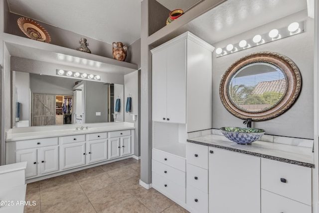 10897 S Turtle Dove Dr S, Goodyear, AZ 85338 - full bathroom featuring two vanities and tile patterned floors