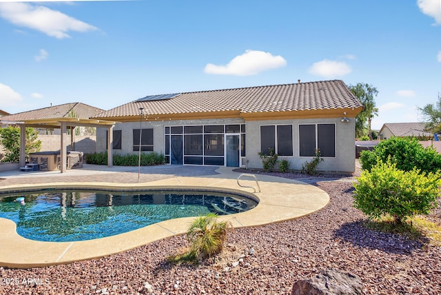 10897 S Turtle Dove Dr S, Goodyear, AZ 85338 - rear view of house featuring a tiled roof, an outdoor pool, a patio, stucco siding, and solar panels