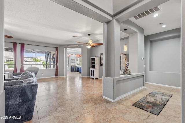 10897 S Turtle Dove Dr S, Goodyear, AZ 85338 - living area with ceiling fan, light tile patterned flooring, and recessed lighting