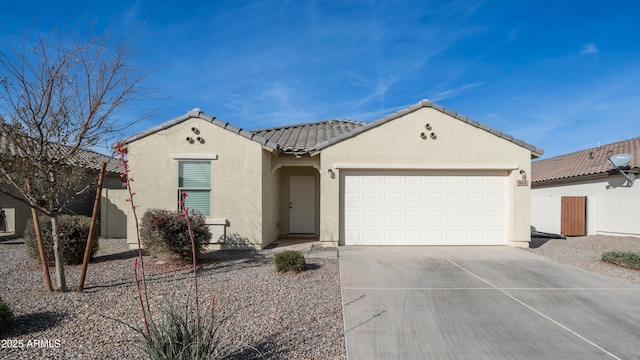 821 S Parker Pl, Casa Grande, AZ 85122 - view of front of home with stucco siding, driveway, a tile roof, and an attached garage