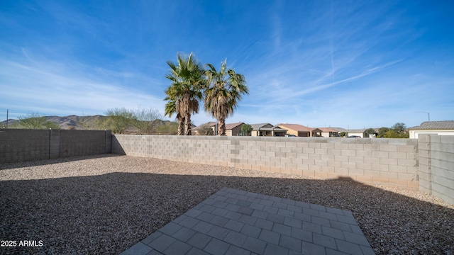 view of yard featuring a residential view, a fenced backyard, and a patio