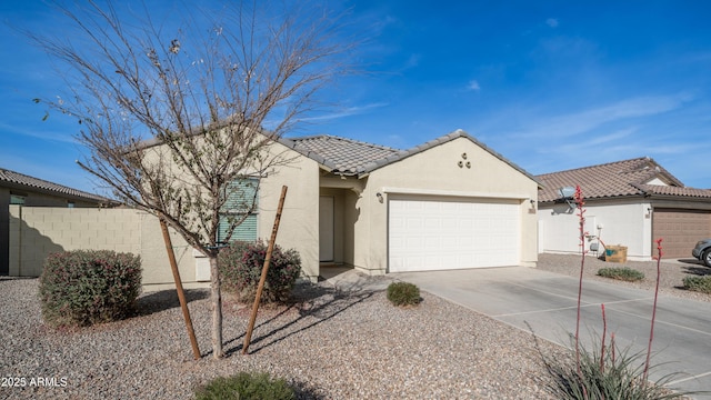 single story home featuring driveway, a tiled roof, an attached garage, fence, and stucco siding