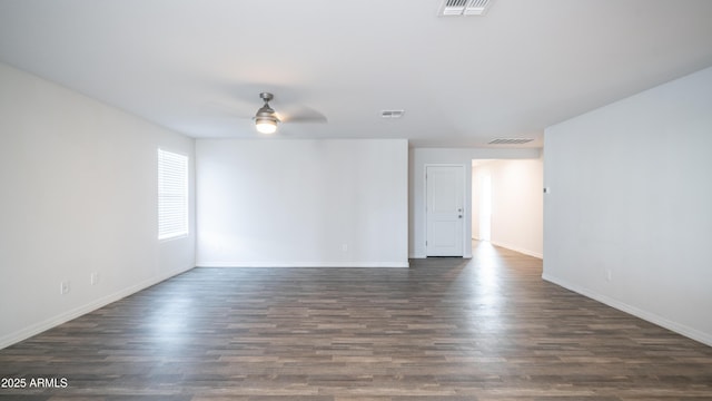 spare room with dark wood-style floors, visible vents, and a ceiling fan