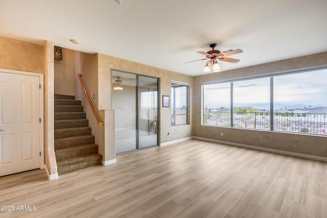 unfurnished room featuring ceiling fan and light wood-type flooring