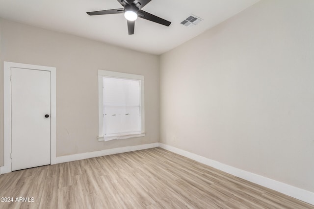 spare room with ceiling fan and light wood-type flooring