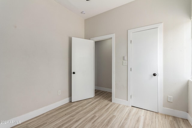 unfurnished bedroom featuring light wood-type flooring