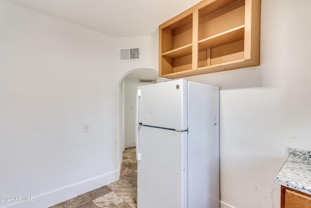 kitchen featuring white fridge and light tile patterned floors