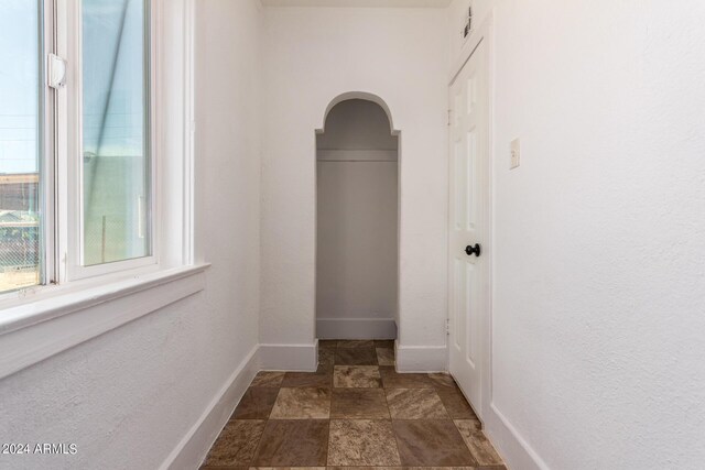 corridor featuring dark tile patterned flooring