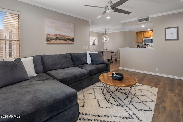 living room with ornamental molding, ceiling fan, and dark hardwood / wood-style floors