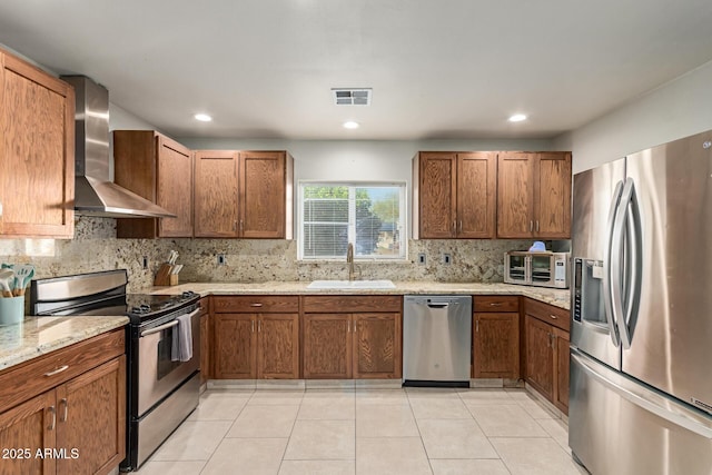 332 S 83rd Pl, Mesa, AZ 85208 - kitchen with appliances with stainless steel finishes, wall chimney exhaust hood, brown cabinets, and recessed lighting