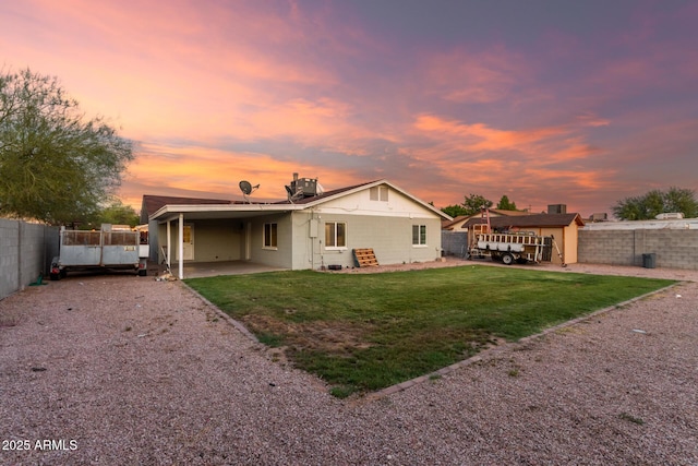 332 S 83rd Pl, Mesa, AZ 85208 - back of property at dusk featuring a fenced backyard, driveway, concrete block siding, and an attached carport