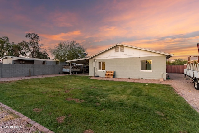 332 S 83rd Pl, Mesa, AZ 85208 - back of house at dusk featuring a fenced backyard and concrete block siding