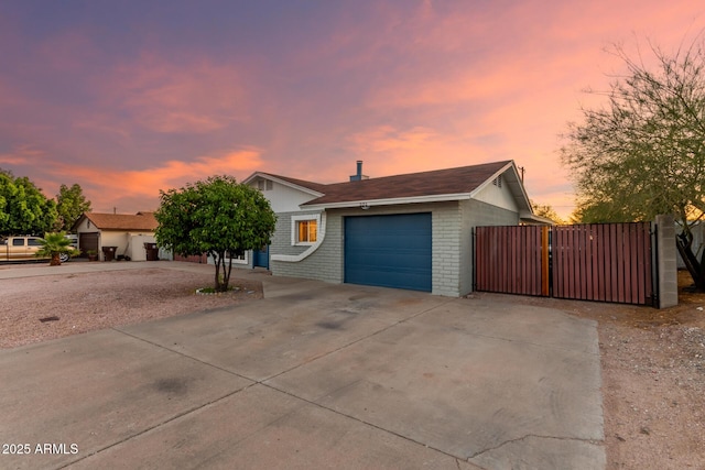 332 S 83rd Pl, Mesa, AZ 85208 - view of front of house with an attached garage, brick siding, concrete driveway, and a gate