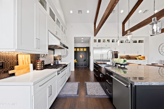 kitchen featuring pendant lighting, sink, beam ceiling, white cabinetry, and stainless steel appliances