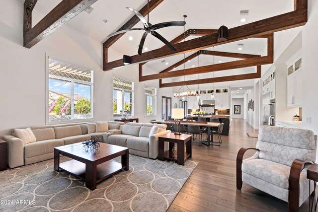 living room with high vaulted ceiling, ceiling fan with notable chandelier, beamed ceiling, and hardwood / wood-style flooring