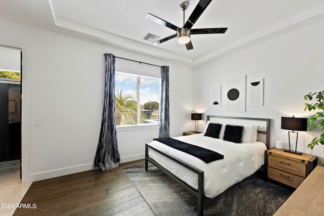 bedroom featuring ceiling fan and dark wood-type flooring