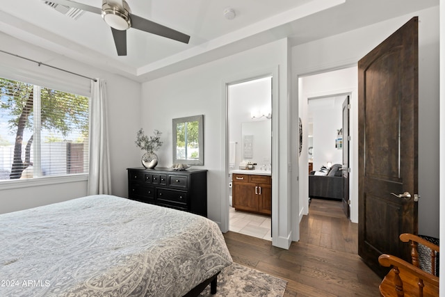 bedroom featuring wood-type flooring, ensuite bathroom, multiple windows, and ceiling fan